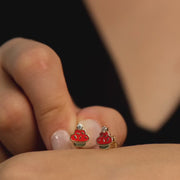 Hand holding the 14ct gold cupcake earrings to show size and detailing