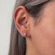 Video of model wearing teardrop gold stud earrings with CZ