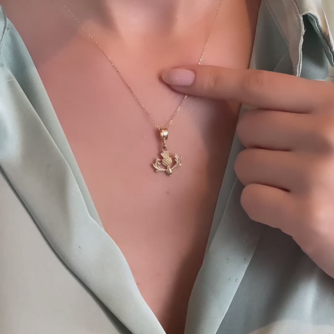 Woman wearing large gold thistle necklace statement piece