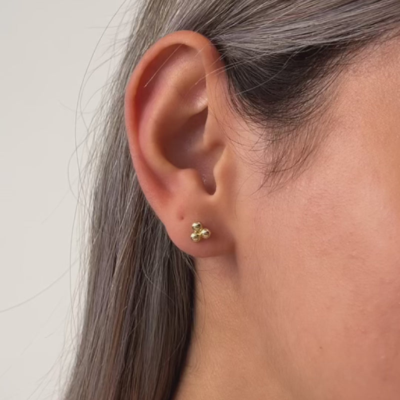 14k gold stud earrings on a model