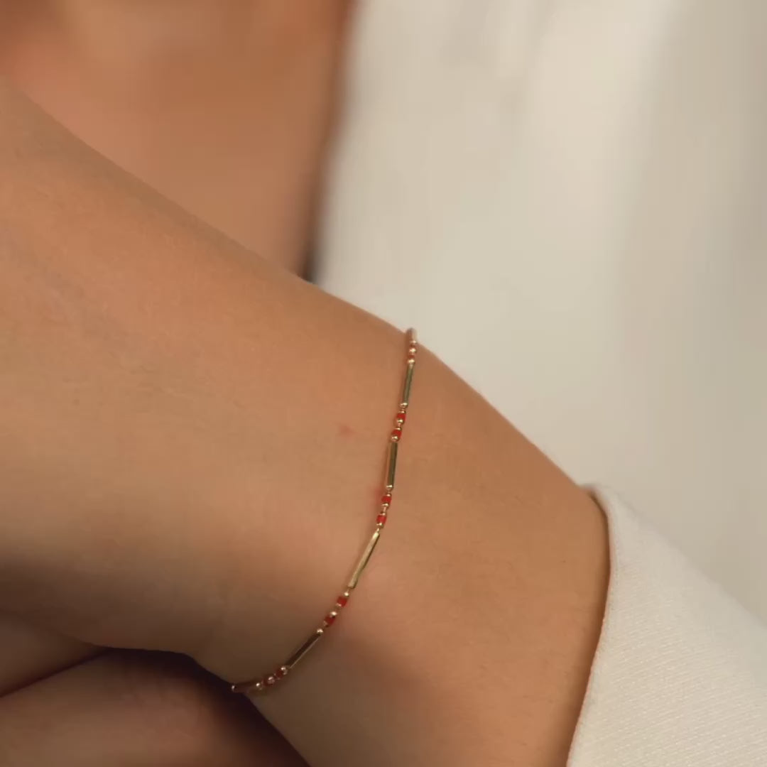 Elegant 14ct gold beaded bracelet with red gemstones, delicate and sophisticated