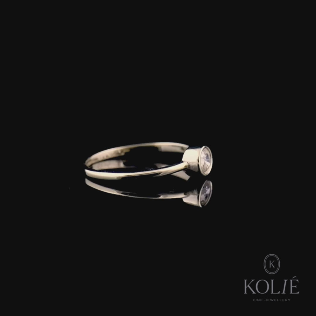 Kolié 9ct yellow gold ring with a modern solitaire cubic zirconia in a bezel setting, offering a sleek and contemporary look.