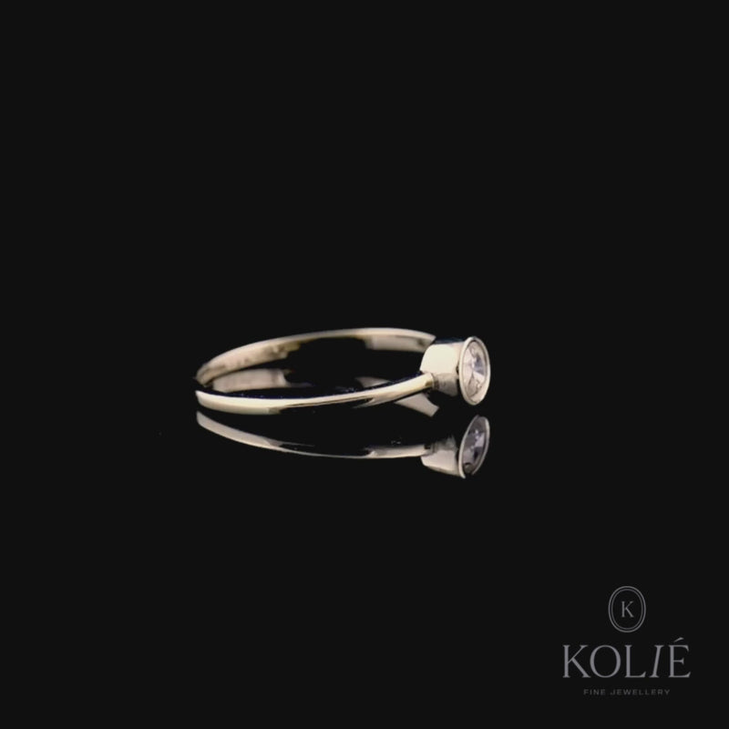 Kolié 9ct yellow gold ring with a modern solitaire cubic zirconia in a bezel setting, offering a sleek and contemporary look.