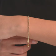 Video of a woman wearing the 14ct gold delicate chain bracelet, showing its elegant design on her wrist.