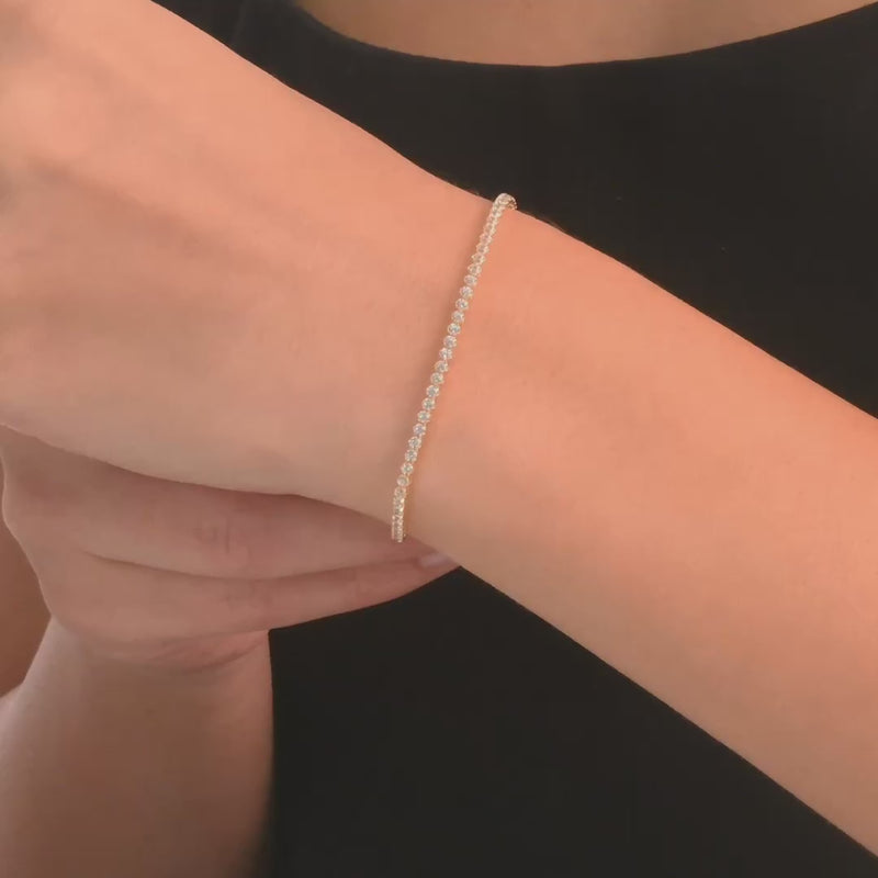 Video of,woman wearing the 14ct gold bracelet with crystal cubic zirconia, showcasing its brilliant sparkle