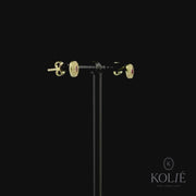 Kolié 9ct yellow gold stud earrings with central pink zirconia and clear zirconia halo, perfect for adding elegance to any outfit.