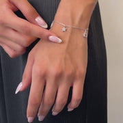 Delicate white gold bracelet with cubic zirconia star and heart charms on wrist