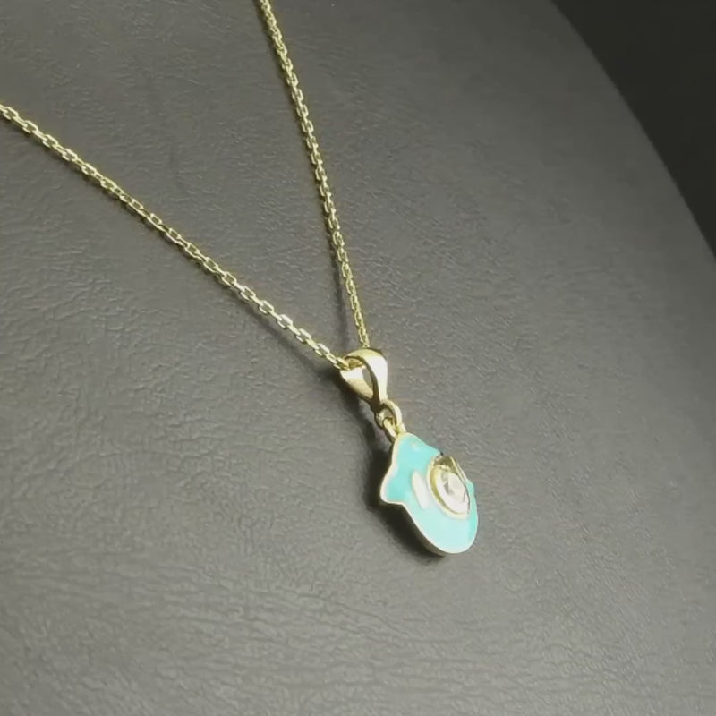 Dolphin pendant, showcasing the enamel detailing and sparkling cubic zirconia