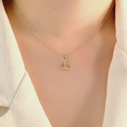 14ct solid gold crown pendant on a model, showing its elegant fit and design.