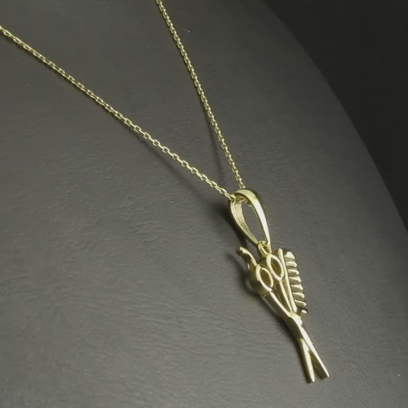 Video of scissors and comb pendant, highlighting its intricate gold craftsmanship