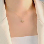 Model wearing the gold angel&infinity pendant to highlight its elegant fit and size.