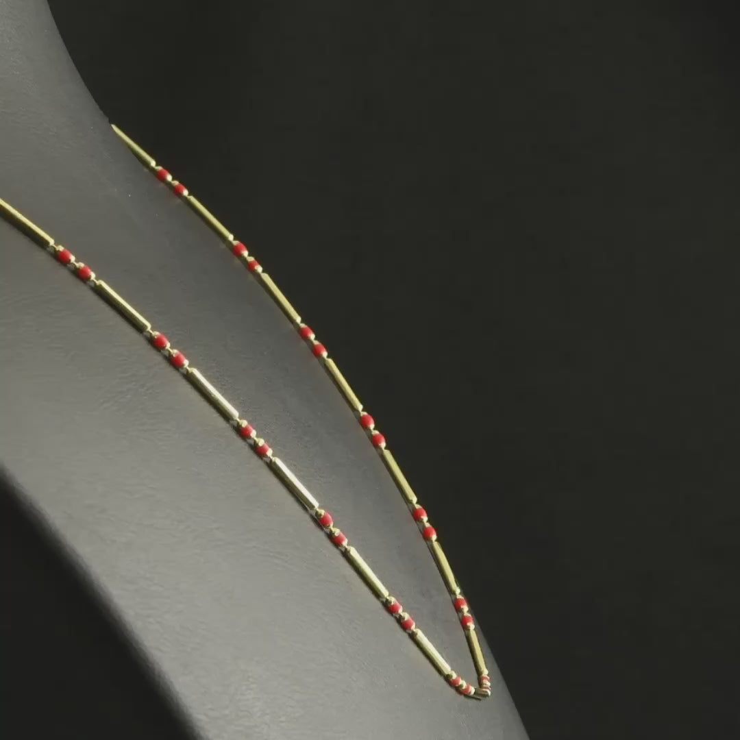 Video of elegant 14ct gold beaded necklace with red gemstones, lightweight and sophisticated.