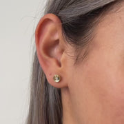 Circle gold stud earrings worn by model